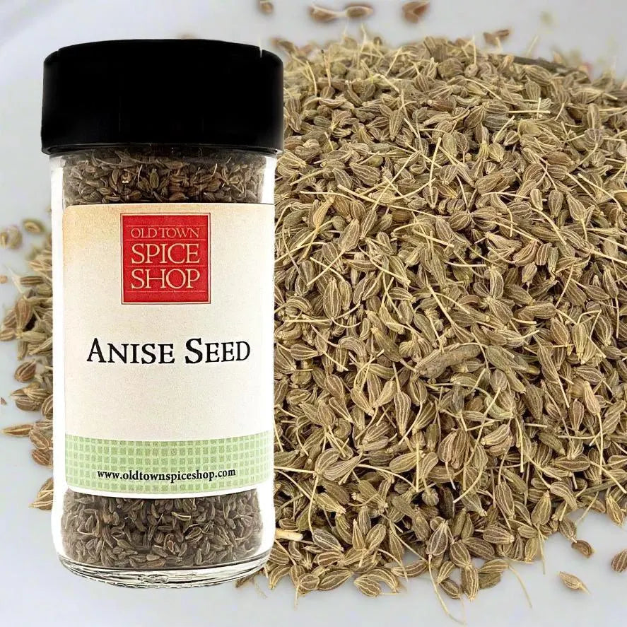Jar of anise seed with Old Town Spice Shop label next to a pile of anise seeds.