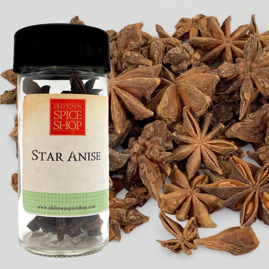 Jar of star anise with a visible label and star anise seeds on a white background