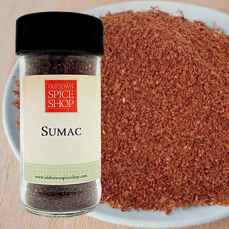 Jar of Old Town Spice Shop Sumac next to a bowl of sumac powder