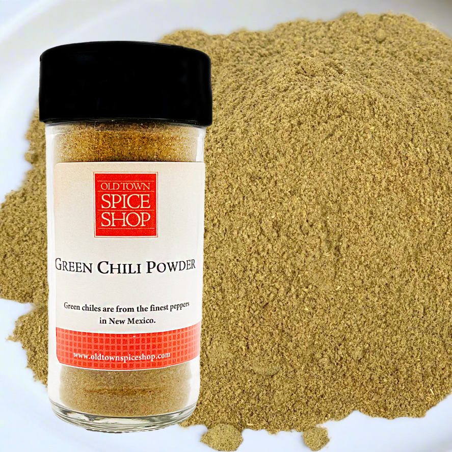 Jar of Old Town Spice Shop Green Chilli Powder with spilled powder on a white plate