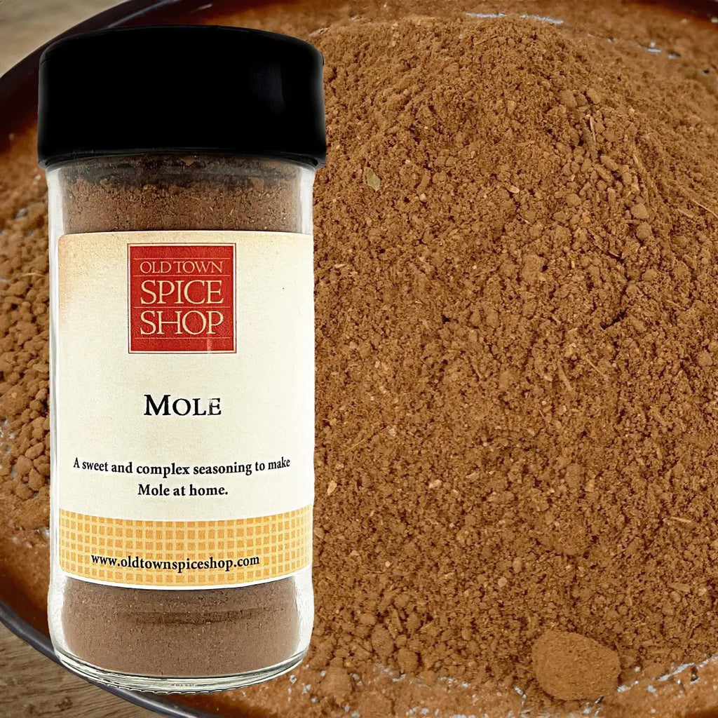 Jar of Old Town Spice Shop Mole spice with a close-up of the spice in the background.