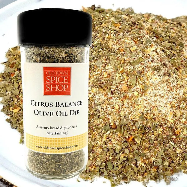 Spice jar labeled 'Citrus Balance Olive Oil Dip' from Old Town Spice Shop on a textured surface.