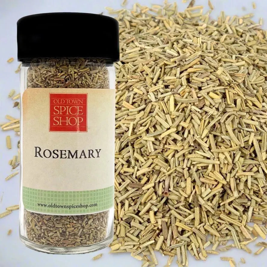 Jar of rosemary from Old Town Spice Shop with rosemary leaves on a white background