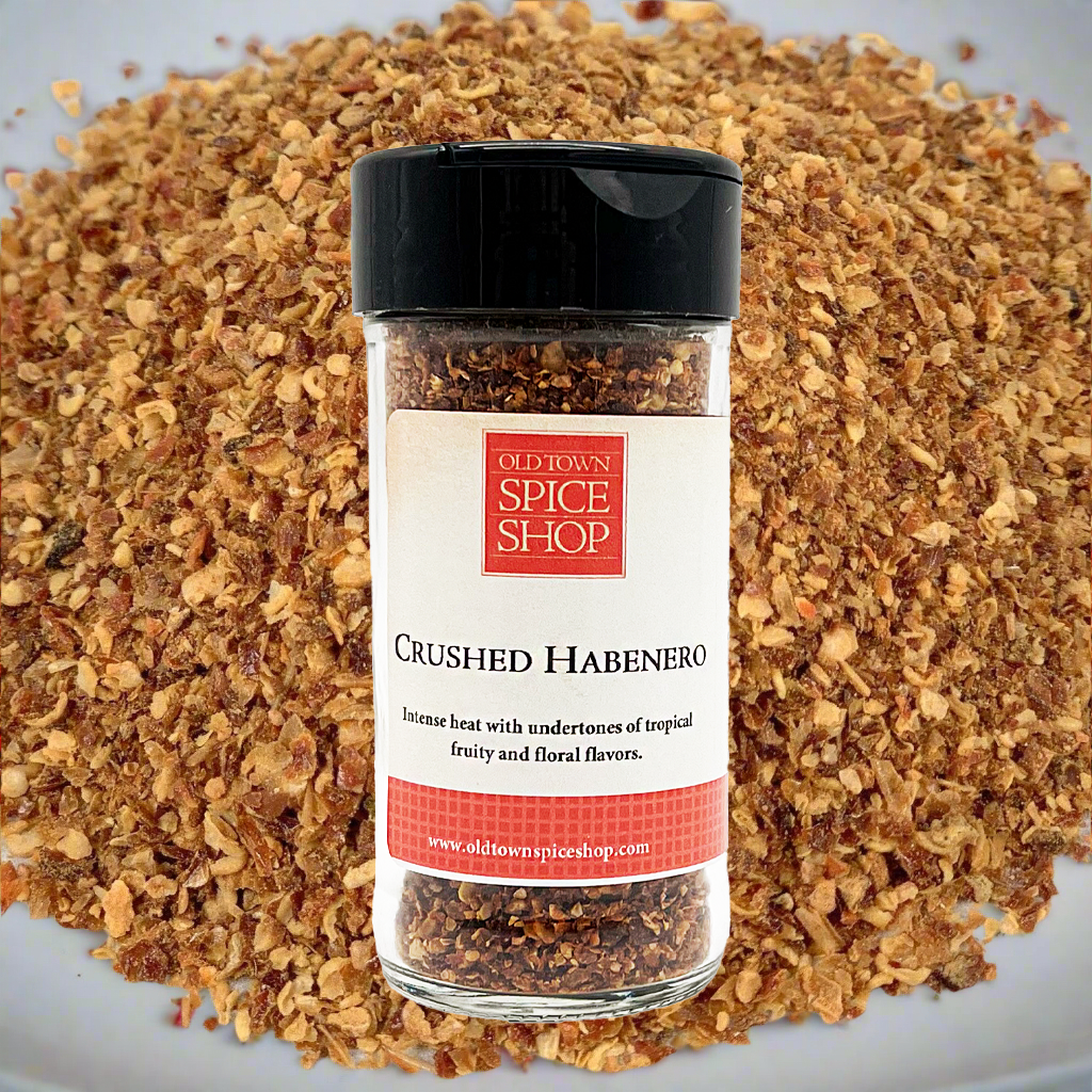 Jar of Old Town Spice Shop crushed habenero pepper with habenero flakes in the background