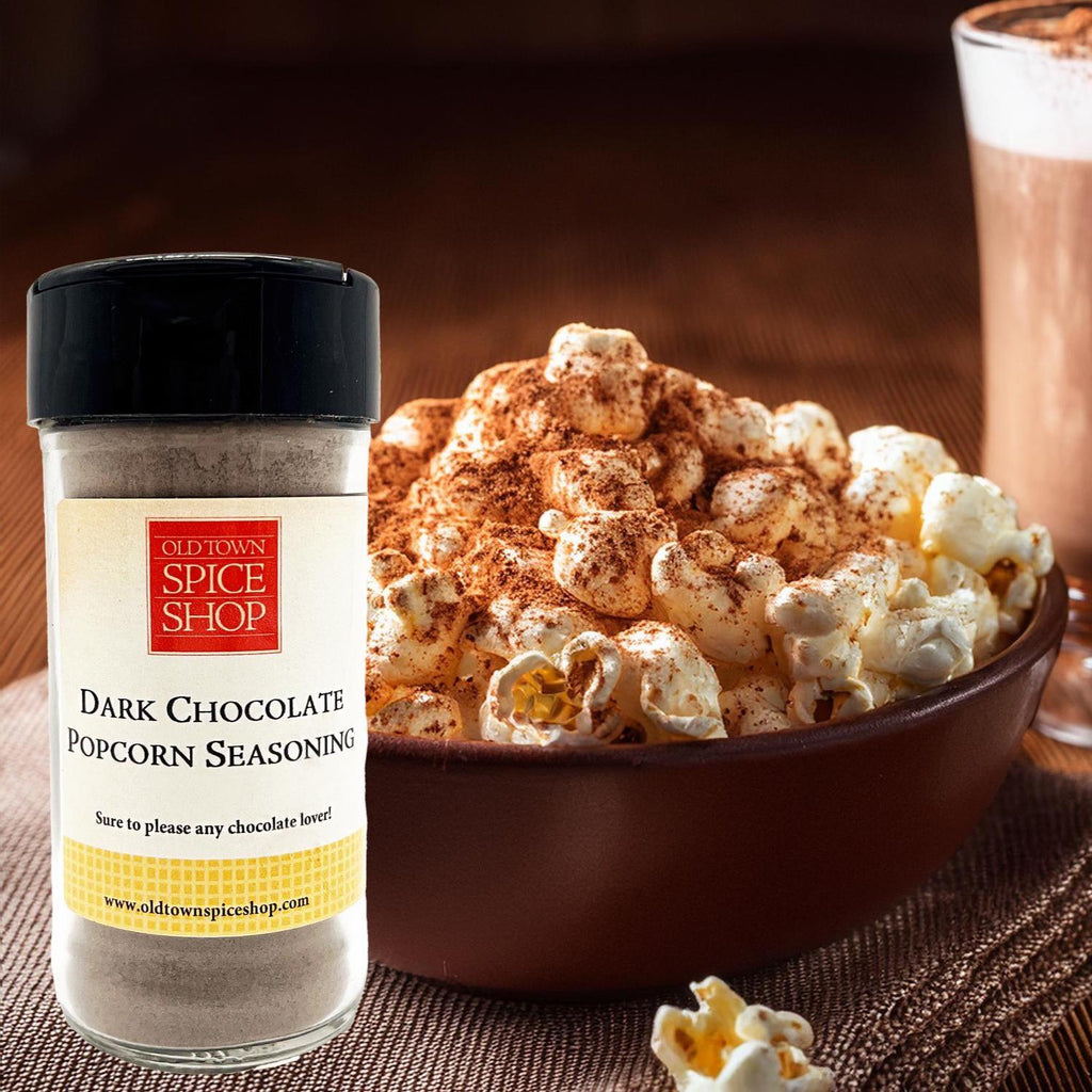 Bottle of Old Town Spice Shop Dark Chocolate Popcorn Seasoning next to a bowl of popcorn.