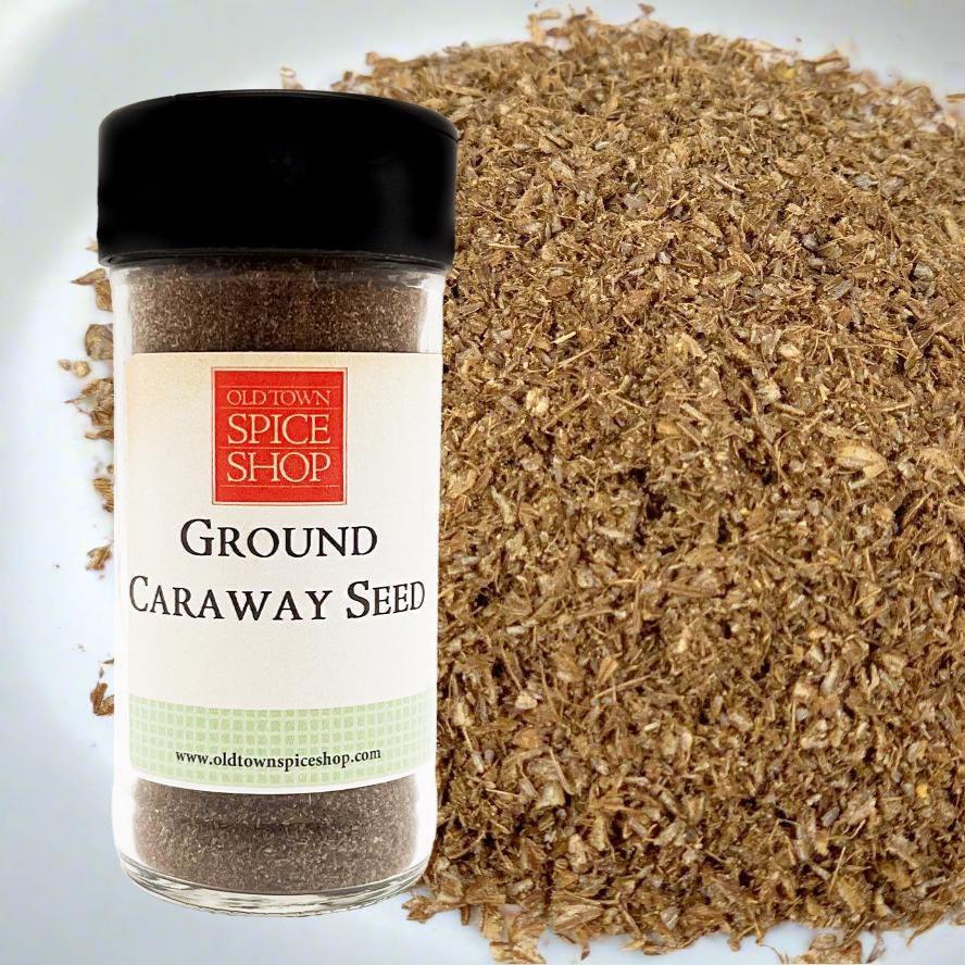 Bottle of Old Town Spice Shop Ground Caraway Seed with caraway seed on a white background