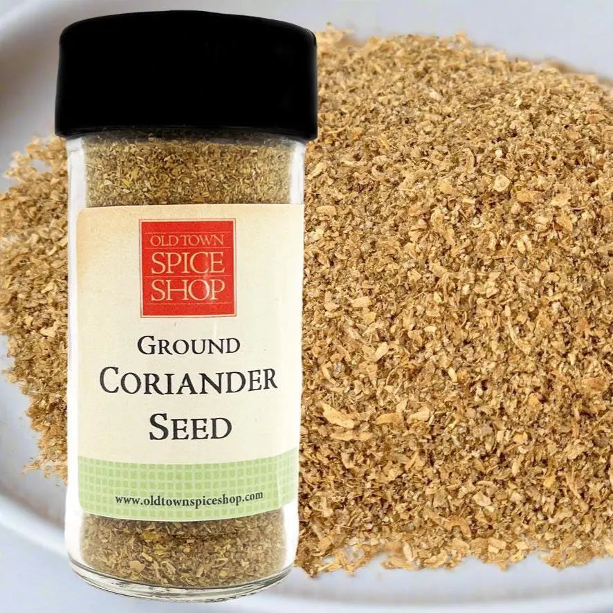 Jar of Old Town Spice Shop Ground Coriander Seed with coriander seed on a white background