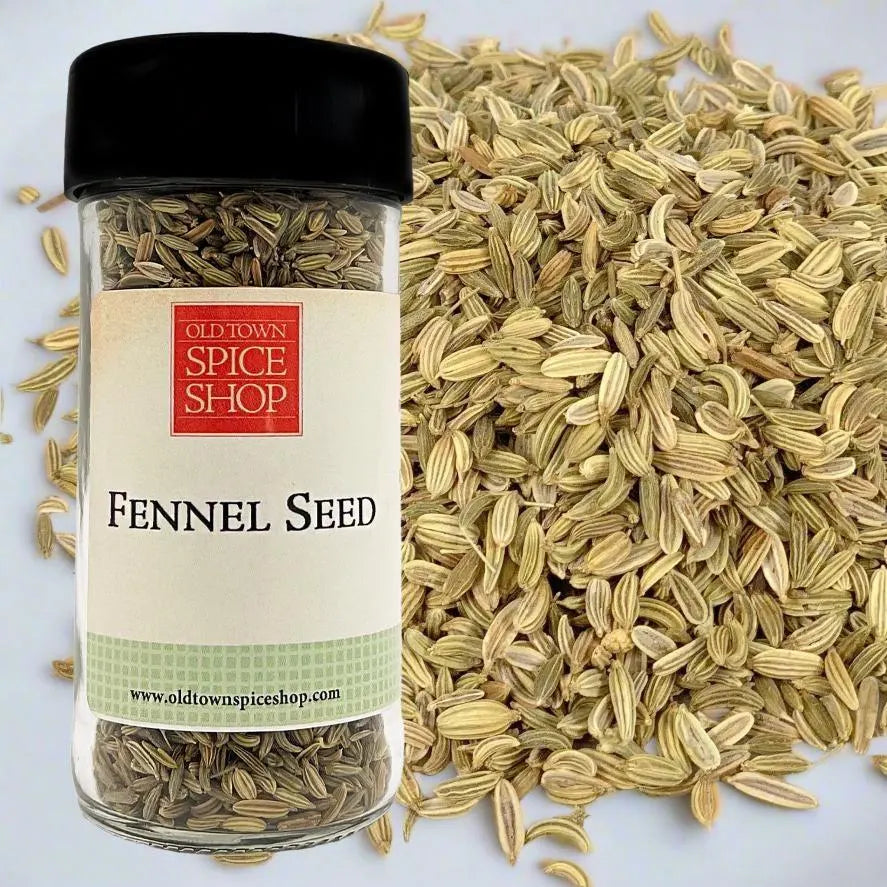 Jar of fennel seeds from Old Town Spice Shop surrounded by fennel seeds on a white background