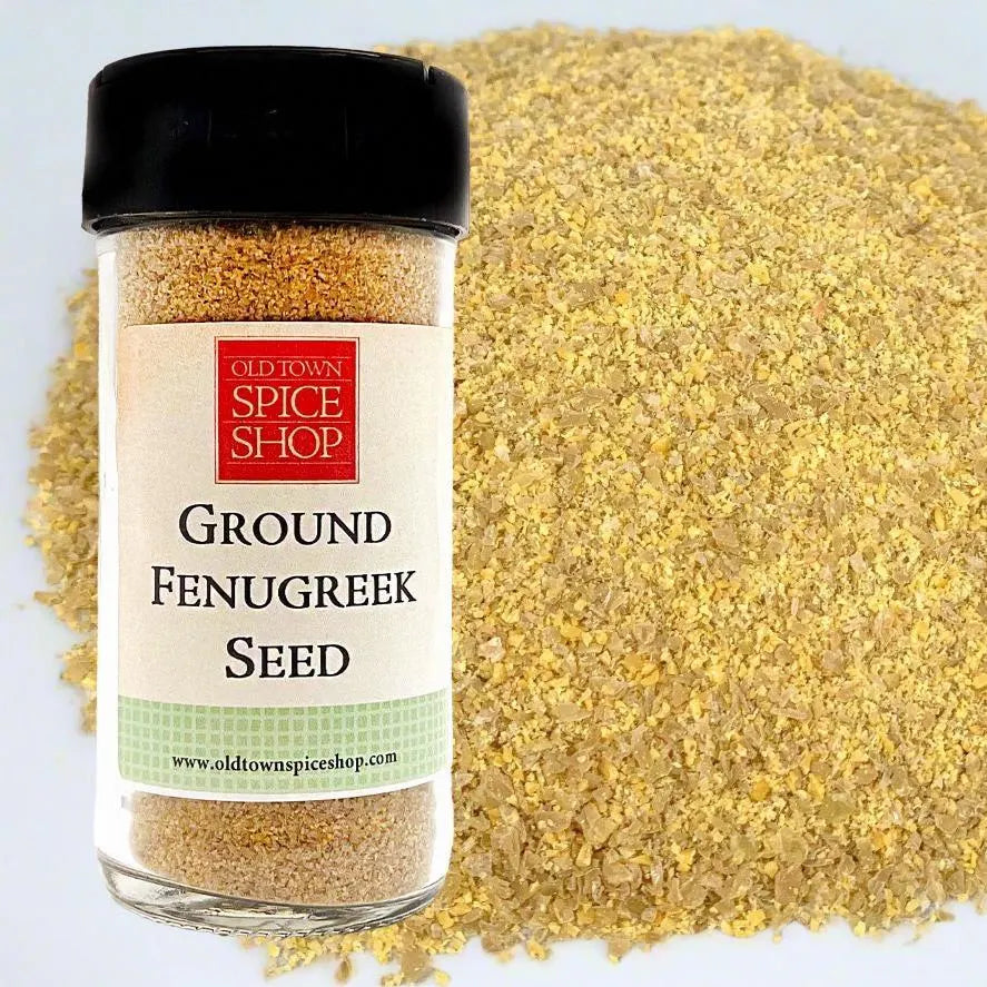 Jar of ground fenugreek seed with a visible label on a light blue background