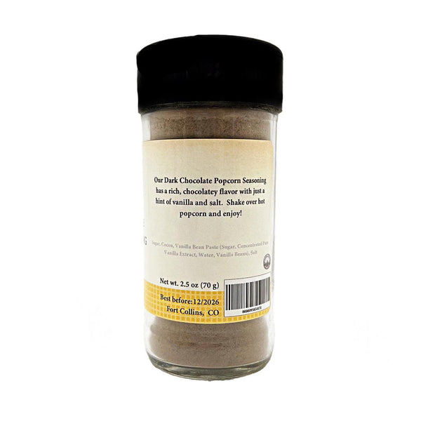 Glass jar of dark chocolate popcorn seasoning with a black lid on a white background