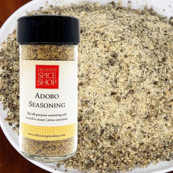 Jar of Old Town Spice Shop Adobo Seasoning with a close-up of the seasoning on a plate.