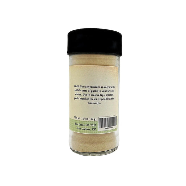 Jar of garlic powder with a black lid on a white background