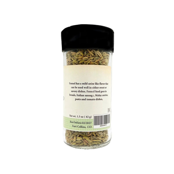 Jar of fennel seeds with a black lid on a white background