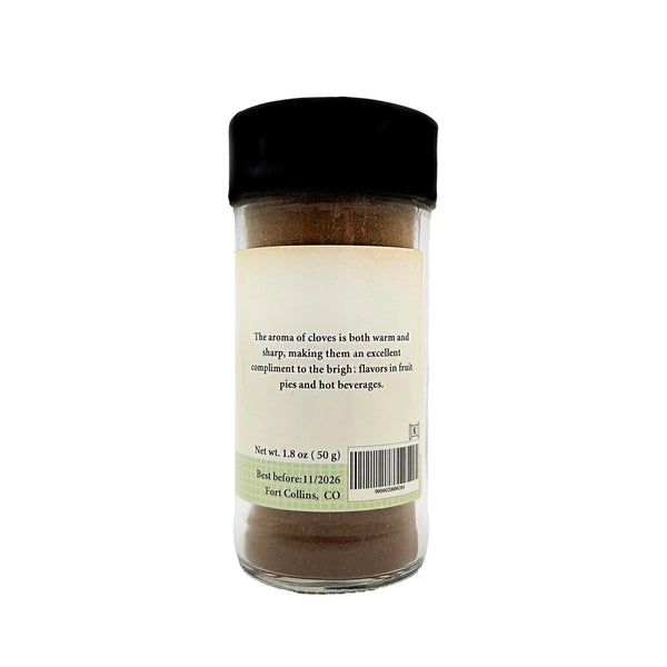 Glass jar of cloves with a black lid on a white background