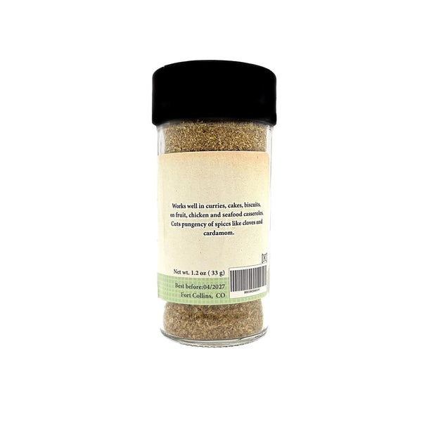 Spice jar with black lid on a white background