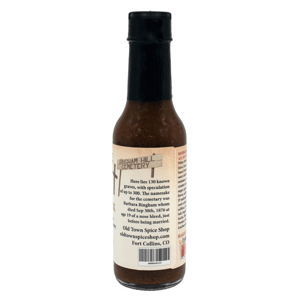 Hot sauce bottle with a label on a white background