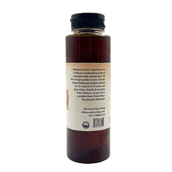 Bottle of Habanero Gold sauce with a label on a white background