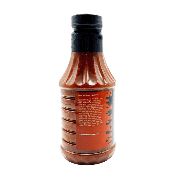 Bottle of sauce with a black cap on a white background