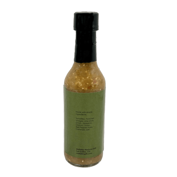 Bottle of hot sauce with a green label on a white background