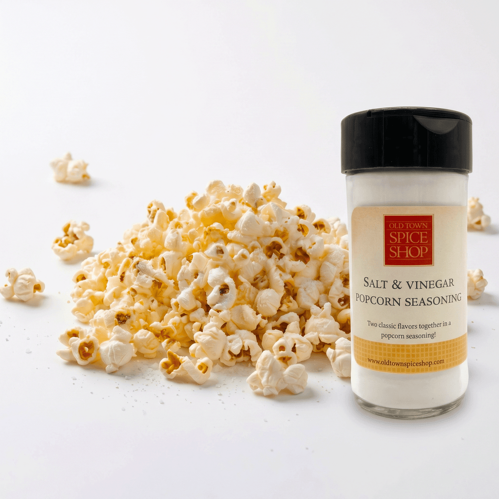 Popcorn and a bottle of Old Town Spice Shop Salt & Vinegar Popcorn Seasoning on a white background