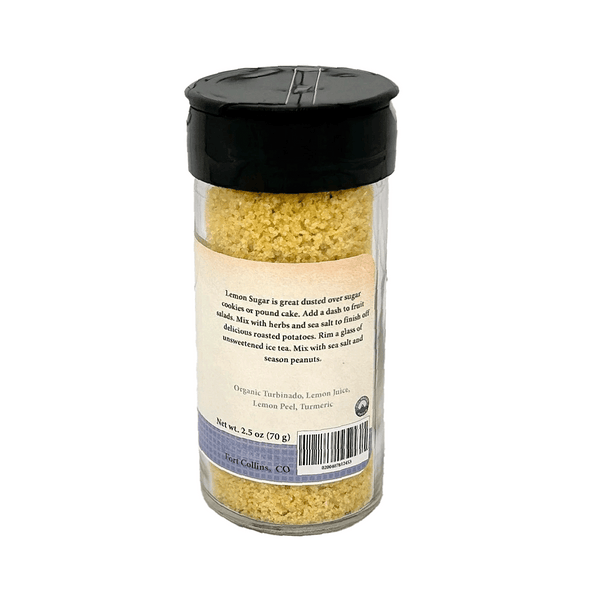 Jar of lemon sugar with a black lid on a white background