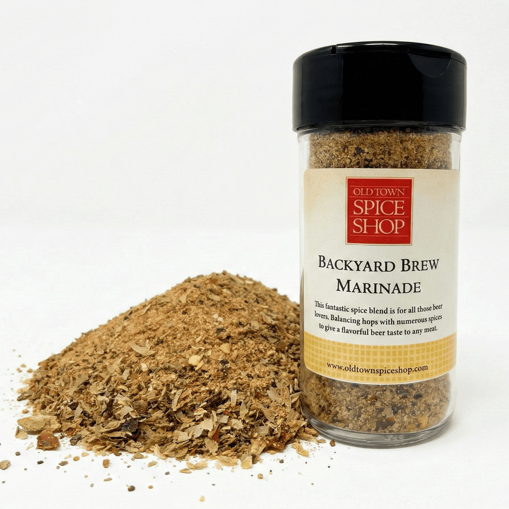 Spice jar labeled 'Backyard Brew Marinade' from Old Town Spice Shop with spilled spices on a white background.