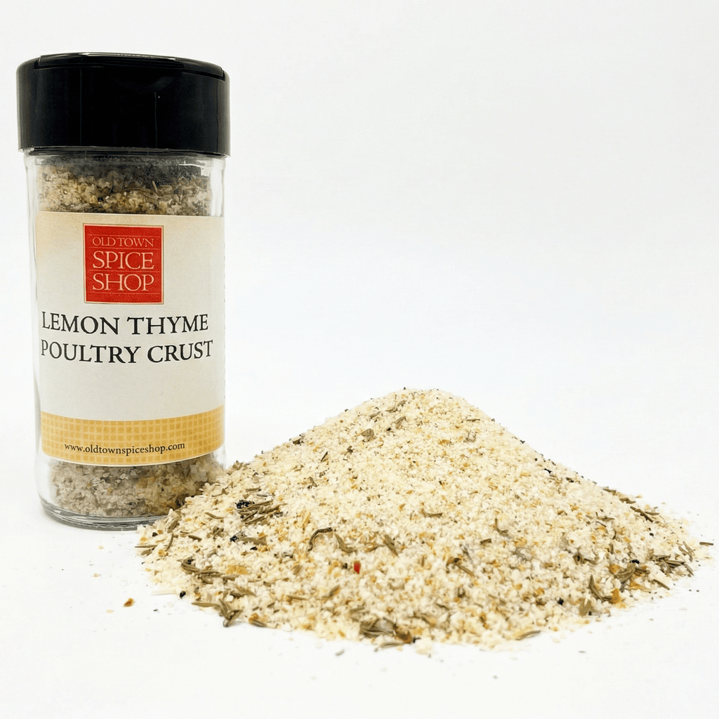 Spice jar labeled 'Lemon Thyme Poultry Crust' from Old Town Spice Shop with a pile of spice mix on a white background.