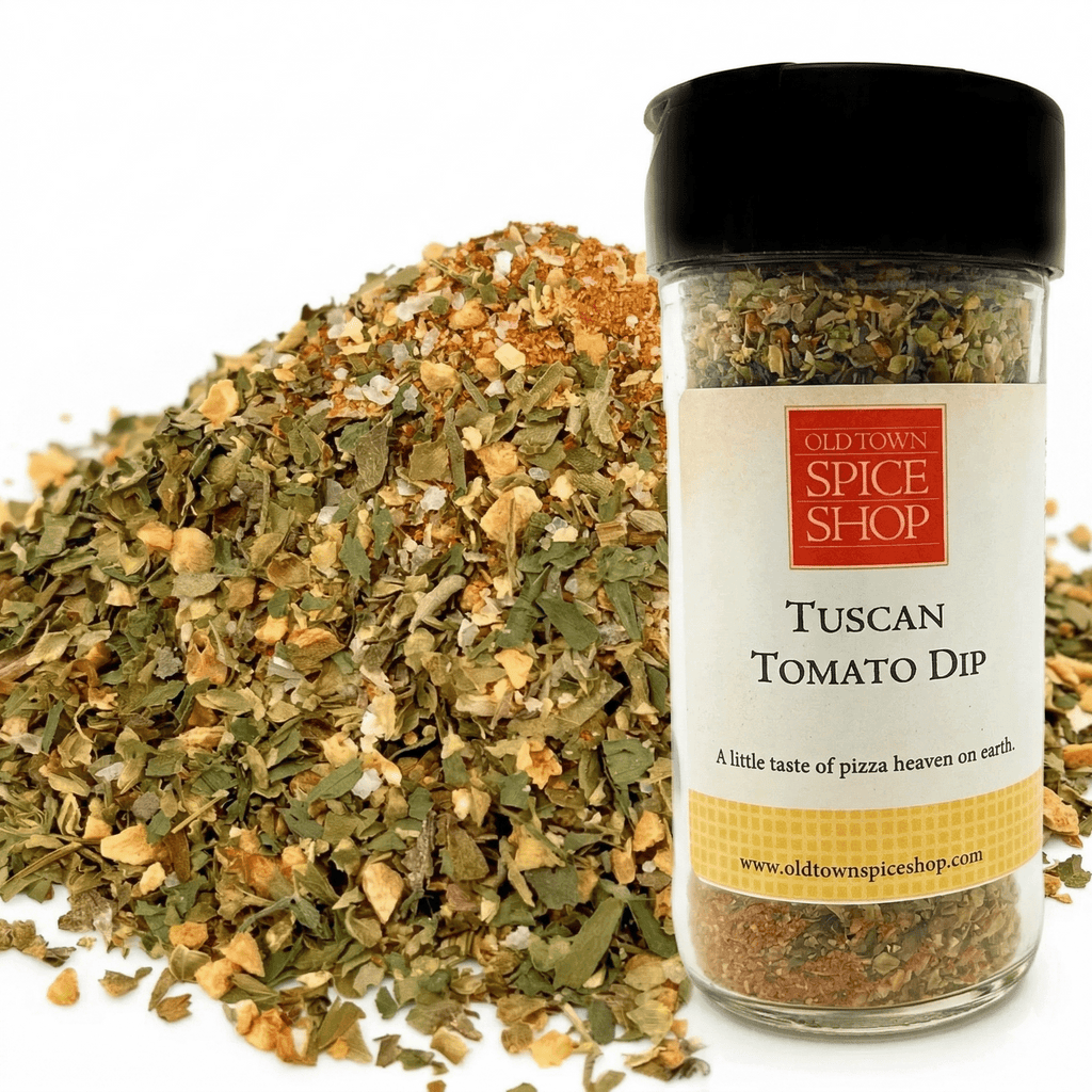 Spice jar labeled 'Tuscan Tomato Dip' from Old Town Spice Shop with dried herbs on a white background