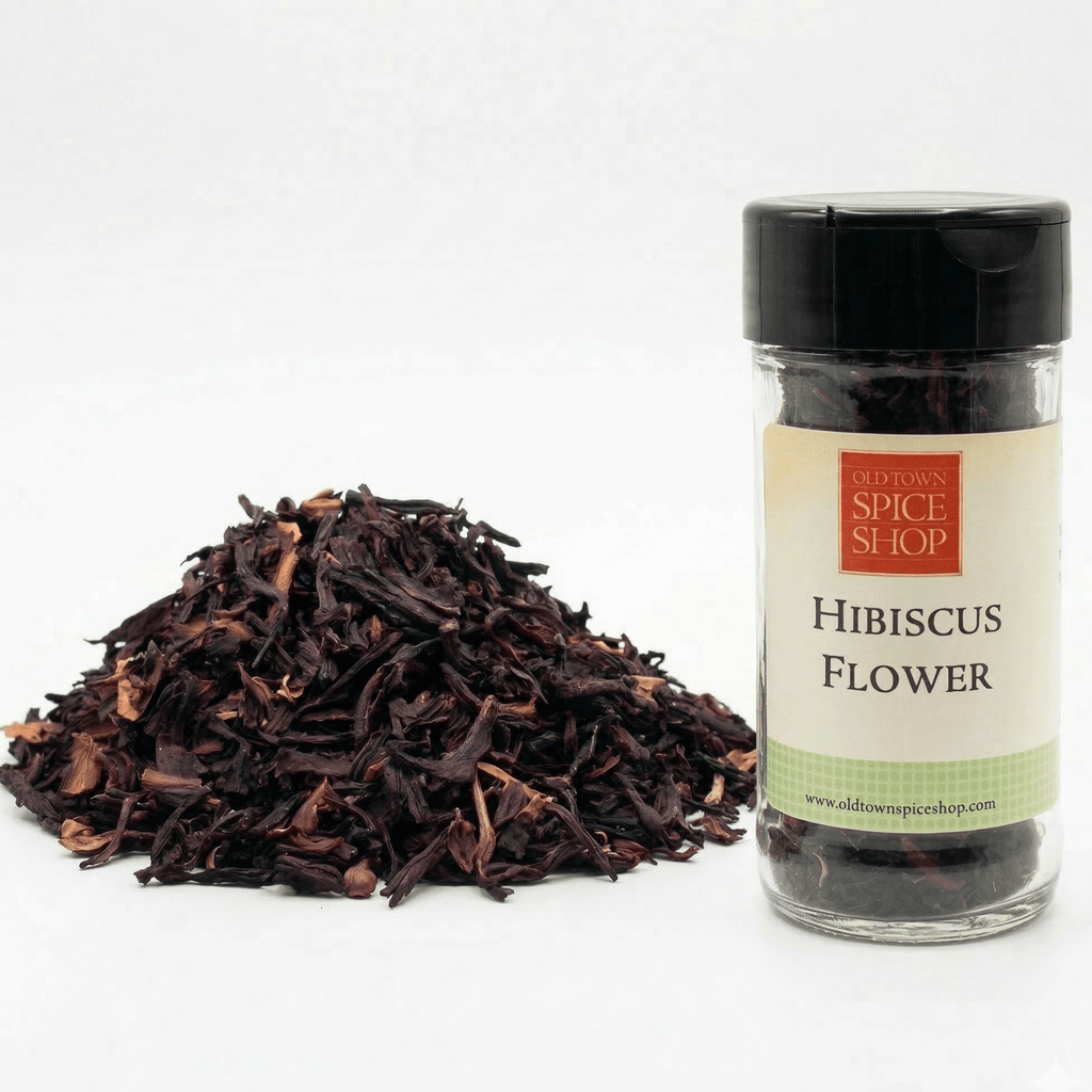 Jar of hibiscus flower from Old Town Spice Shop with dried hibiscus leaves on a white background