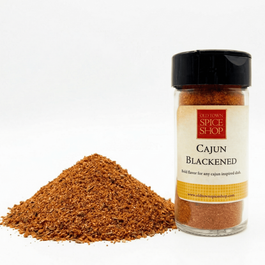 Jar of Cajun Blackened seasoning from Old Town Spice Shop with a pile of the spice on a white background.