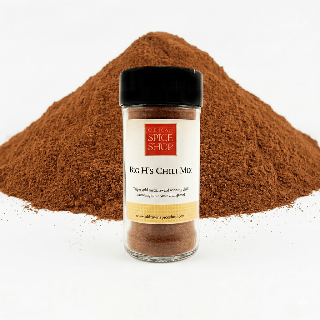 Jar of Big H's Chili Mix from Old Town Spice Shop with chili powder in the background