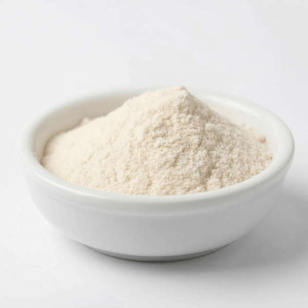 White bowl filled with a powdery substance on a light gray background