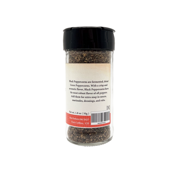 Spice jar with black lid on a white background