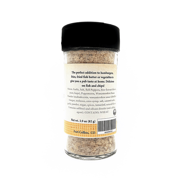 A clear glass spice jar with a black lid and a cream-colored label, showing the back of the packaging for 'Four Golden' seasoning blend on a white background.