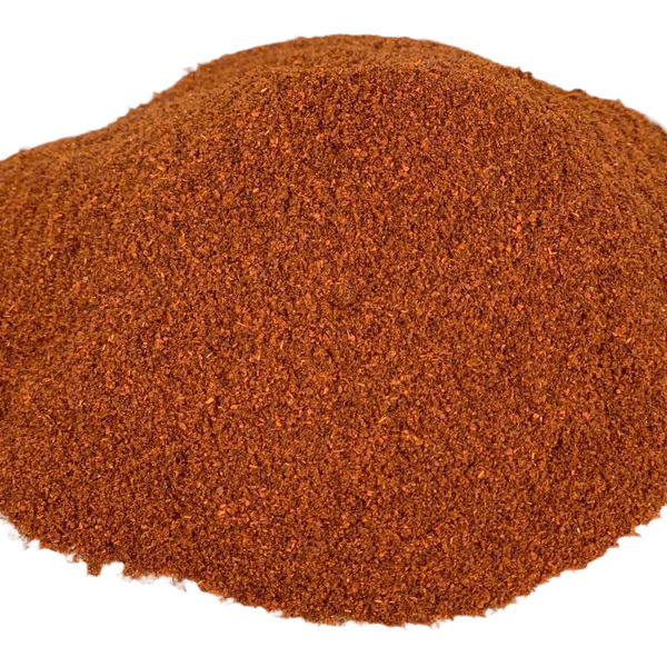 Pile of red chili powder on a white background