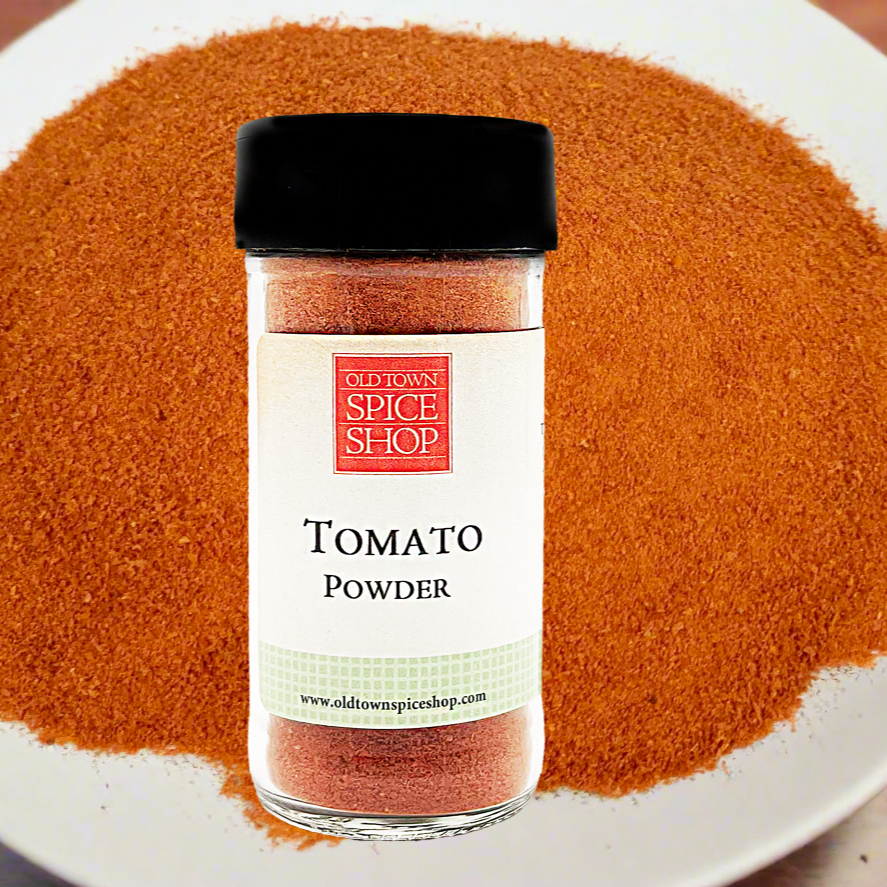 Jar of tomato powder from Old Town Spice Shop on a white plate with tomato powder.