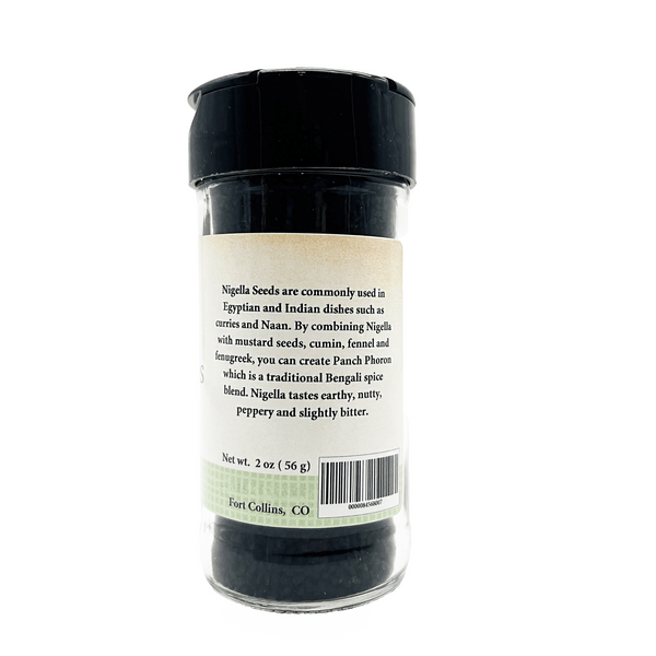 Jar of nigella seeds with a label on a white background
