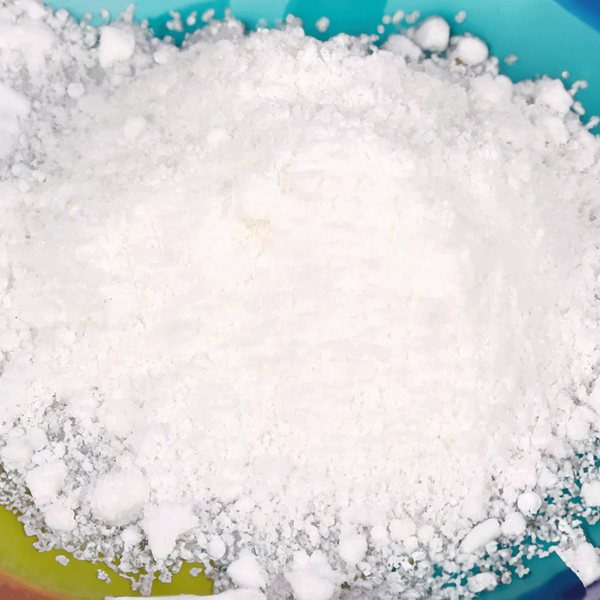 Close-up of white granular material in a blue container