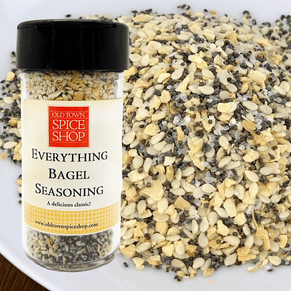Jar of Old Town Spice Shop Everything Bagel Seasoning with spilled seasoning on a white surface