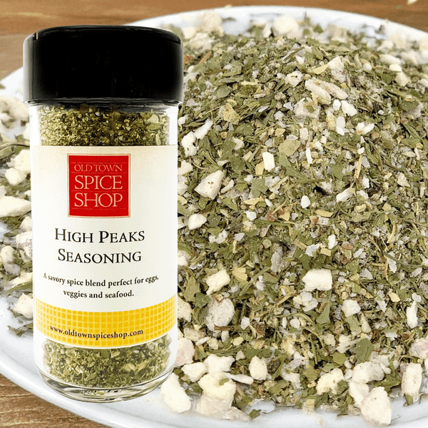 Jar of Old Town Spice Shop High Peaks Seasoning with a pile of seasoning on a white plate.