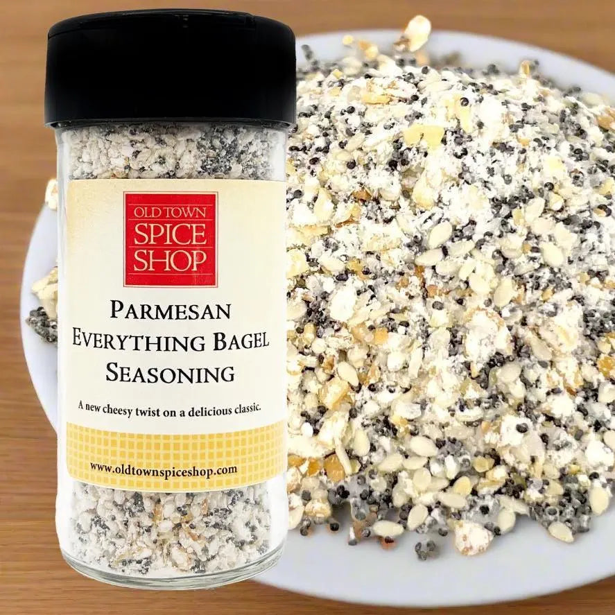 Jar of Old Town Spice Shop Parmesan Everything Bagel Seasoning with a plate of seasoning in the background.